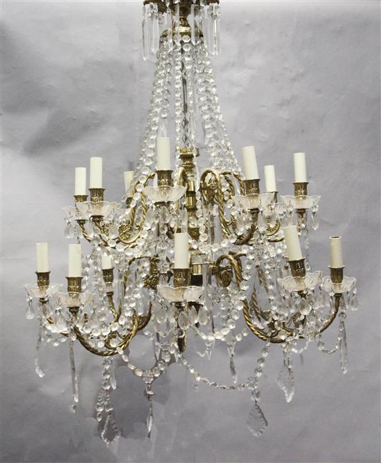 An 18th century style gilt brass and glass sixteen light chandelier, drop 3ft 6in. diam.2ft 8in.